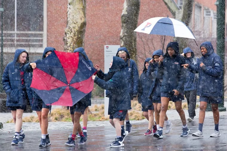 Members of the Penn Women's basketball team walk on campus as snow falls, Friday, March 10, 2017.