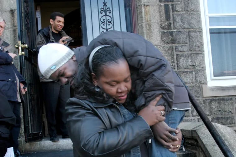 Crystal Brown carries her son, Chris, down the steps of St. Martin de Porres Church in 2006.