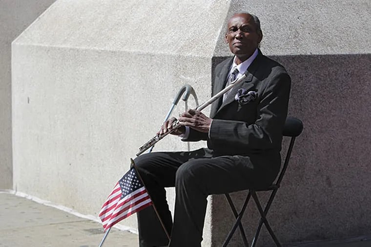 Felix Wilkins, a well-known street performer, is suing Reading Terminal after being harassed and injured by security and police for playing his flute at the Terminal. Wilkins is picture on the corner of 4th and Market in Philadelphia on April 20, 2014. ( DAVID MAIALETTI / Staff Photographer )
