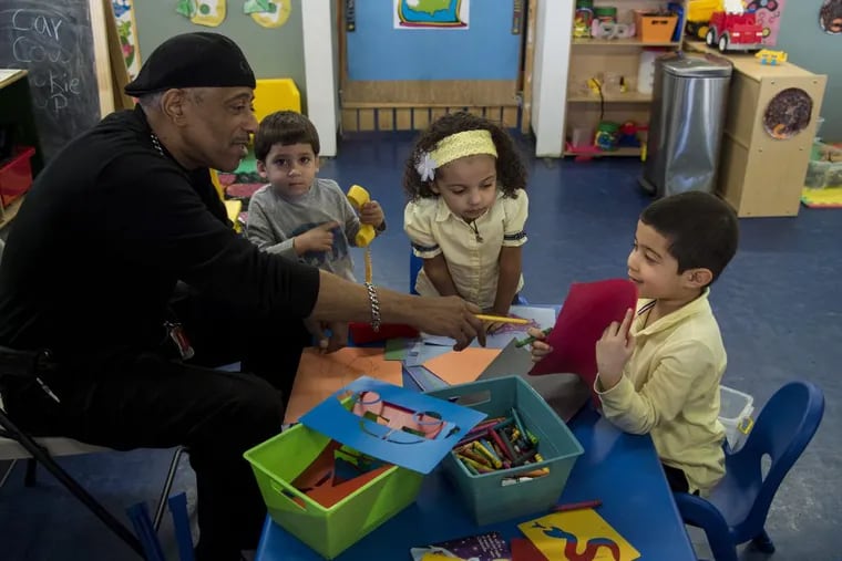 Reggie Jackson, 65, lead teacher and p.m. program director at Amazing Kidz Academy, a pre-K provider in the city’s expanded pre-K program on East Erie Avenue, helping some young students with a project in March.