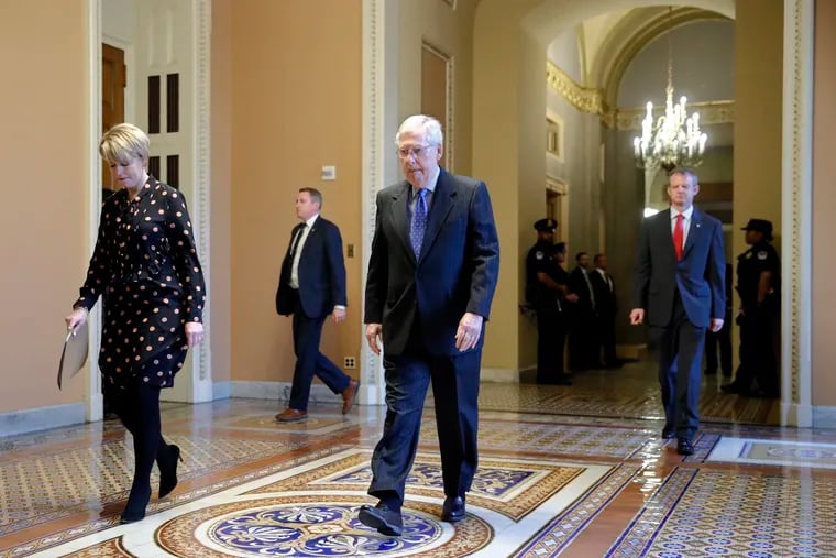 Senate Majority Leader Mitch McConnell walks to the Senate chamber.