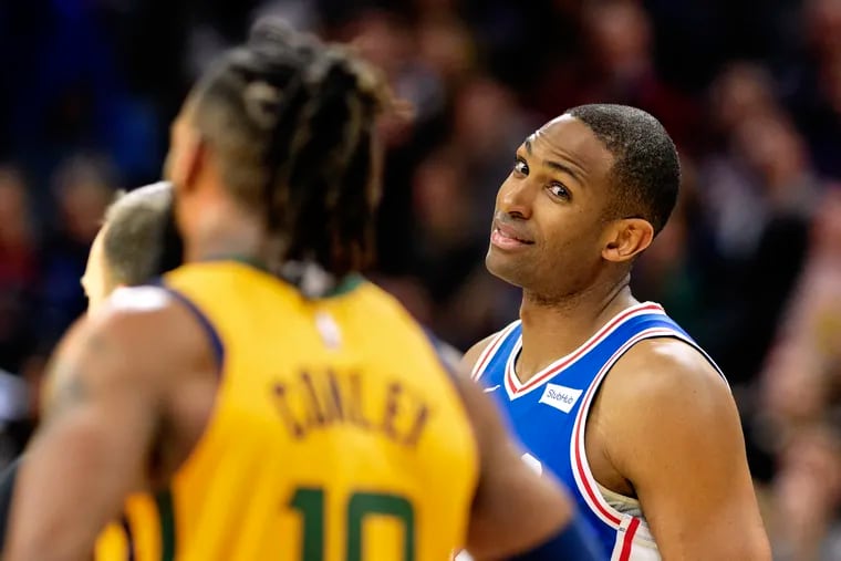 Sixers Al Horford (right) gives the eye to Utah Jazz Mike Conley (left) after he was fouled by Conley in the first half of Monday's game at the Wells Fargo Center.