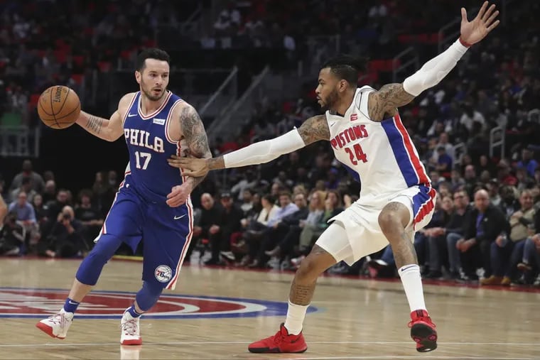 Sixers guard JJ Redick brings the ball up court as Pistons forward Eric Moreland defends during the second half.