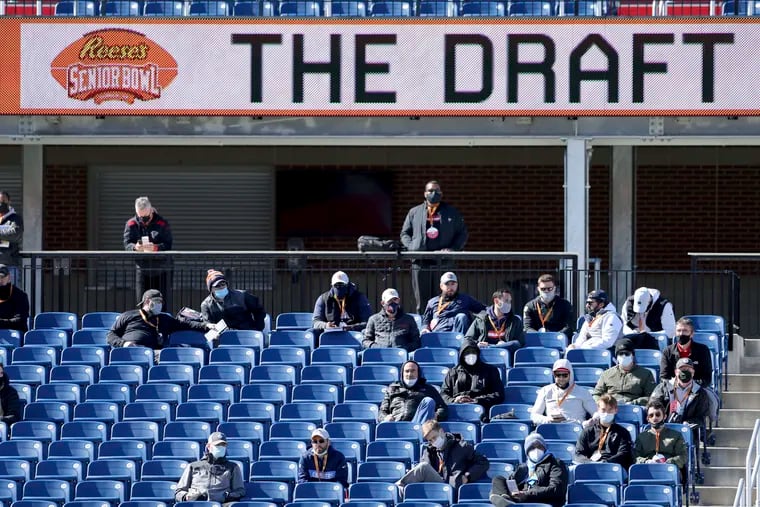 NFL team personnel watching a Senior Bowl practice in Mobile, Ala., in 2021.
