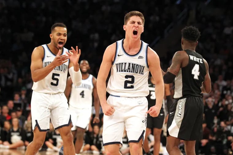 Collin Gillespie (right) and Phil Booth celebrate forcing a Providence turnover during Thursday's Big East Tournament game at Madison Square Garden.