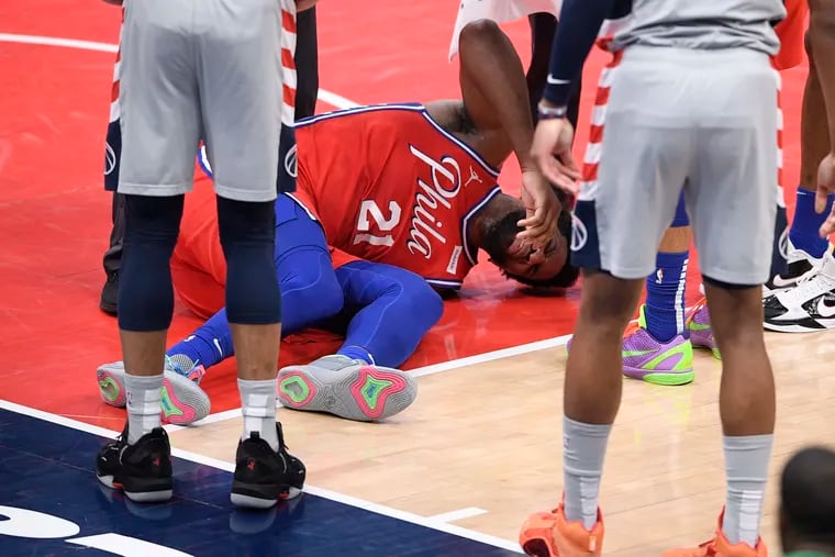 Joel Embiid in obvious pain after suffering a knee injury against the Wizards in Washington on March 12.