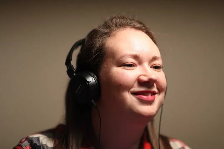 Kimberly Erskine wears headphones to talk on a cell phone. She has a severe hearing loss and has been fitted with a cochlear implant, Monday December 19, 2016