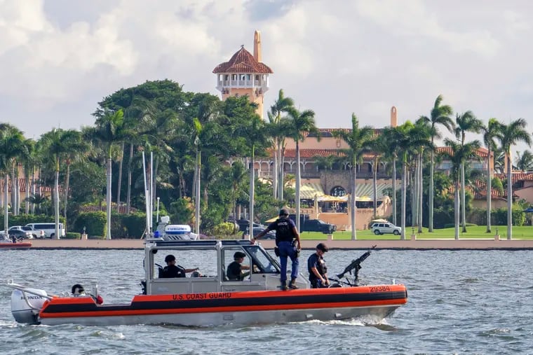 FILE - In this Nov. 22, 2018, photo, a U.S. Coast Guard patrol boat passes President Donald Trump's Mar-a-Lago estate in Palm Beach, Fla. A government watchdog says President Donald Trump’s four trips to Mar-a-Lago in early 2017 cost taxpayers nearly $14 million.