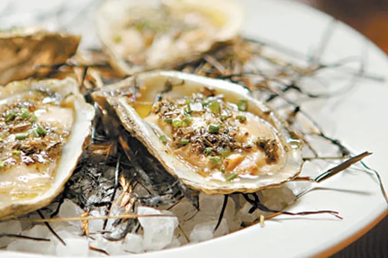 Hay-smoked oysters at Oyster House. (MICHAEL BRYANT / Staff Photographer)