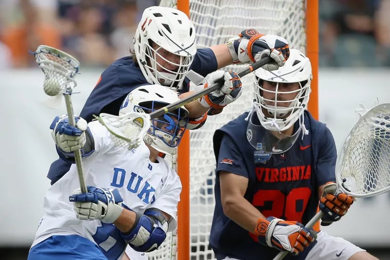 Duke's Joe Robertson (8) prepares to shoot around Virginia's Cade Saustad (11) and Alex Rode (38) during their NCAA men's Division I lacrosse semifinal game at Lincoln Financial Field in South Philadelphia on Saturday, May 25, 2019.
