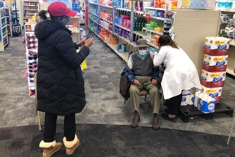 Eddie "Uncle Eddie" Hill of Edgewater Park, who will turn 100 on April 20, is finally able to get his first COVID-19 vaccine on Sunday at the CVS in Gibbsboro. Nikki Samson (left) a member of his Alpha Baptist Church in Willingboro drove him for the shot.