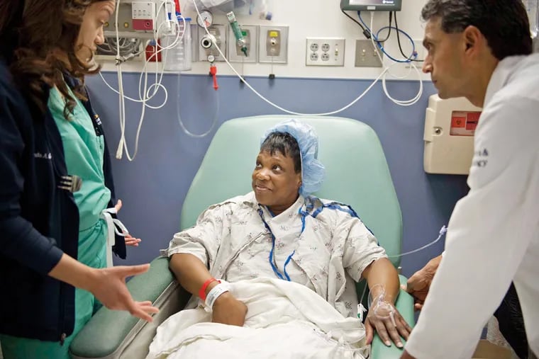 Dr. Minda Green (left) and Dr. Dipak Delvadia (right), both with Drexel Medicine, speak with patient Kelly Hidleburg, of Philadelphia, about the ultrasound procedure which she will receive for fibroids at Hahnemann Hospital in Philadelphia on Monday, April 25, 2016. The procedure was the second of its kind performed in Philadelphia.