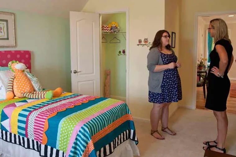 Student Elizabeth Pass (left) talks with teacher Lauren Newman in a room she designed.