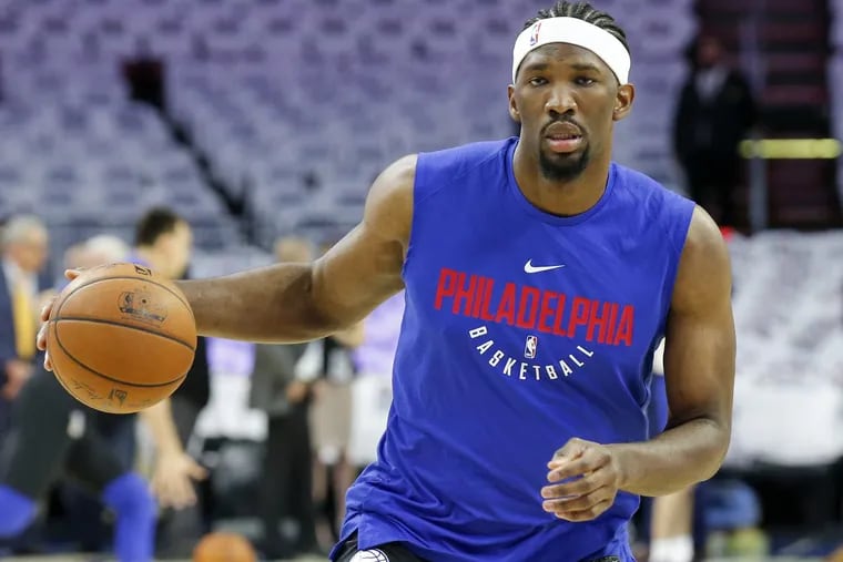 Sixers center Joel Embiid dribbles the basketball during warm-ups before the Sixers play their home opener against the Boston Celtics on Friday.