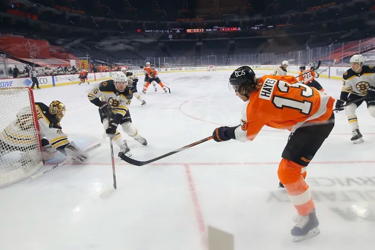 Flyers center Kevin Hayes shoots the puck on the net against Boston Bruins goaltender Tuukka Rask as Jeremy Lauzon defends during the first period Friday.