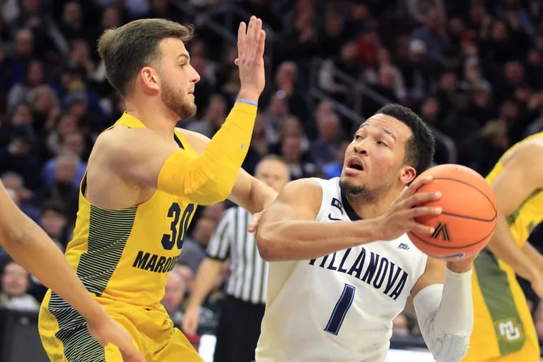 Jalen Brunson, right, of Villanova pump fakes against Andrew Rowsey of Marquette during the 2nd half at the Wells Fargo Center on Jan 6, 2018.