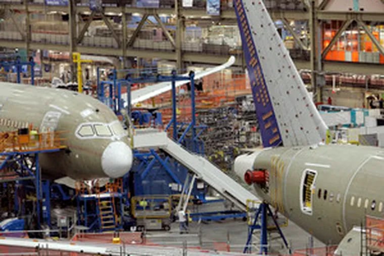 The new 787 jets are lined up at the Everett, Wash., assembly line.