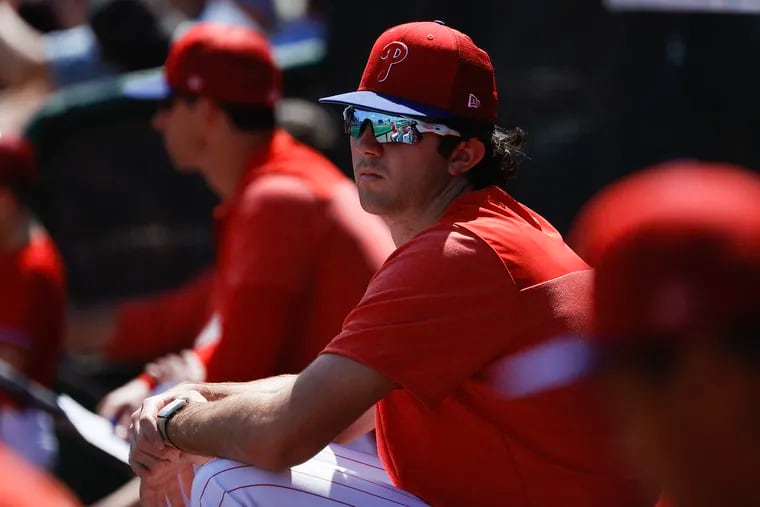 Phillies pitcher Andrew Painter watches his teammates take on the Toronto Blue Jays during a spring training game on March 12 in Clearwater, Fla.