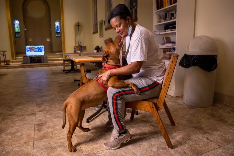 Samantha House with 'Butter Bean,' the 3-year-old Red Nose Pit Bull she raised from a puppy. Originally from West Philadelphia, House  and her dog were experiencing homelessness before they came to Project HOME's Sacred Heart Recovery Residence in Hunting Park about six months ago. Sacred Heart is one of two Project HOME facilities that take people with pets.