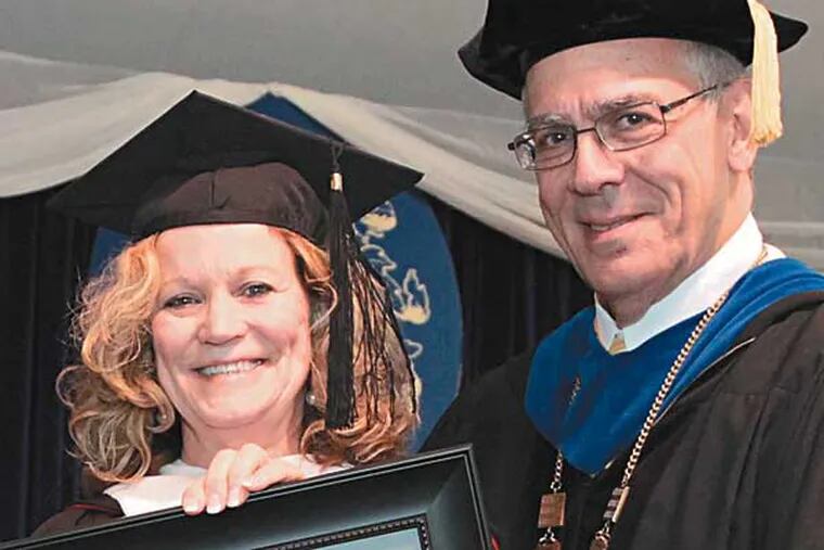 Eileen Radetich, a professor at Camden County College, shows off the 2014 Lindback Distinguished Teaching Award she won May 17, 2014. Raymond Yannuzzi, the president of the college, presented Radetich with the school’s highest teaching honor at the ceremony.
