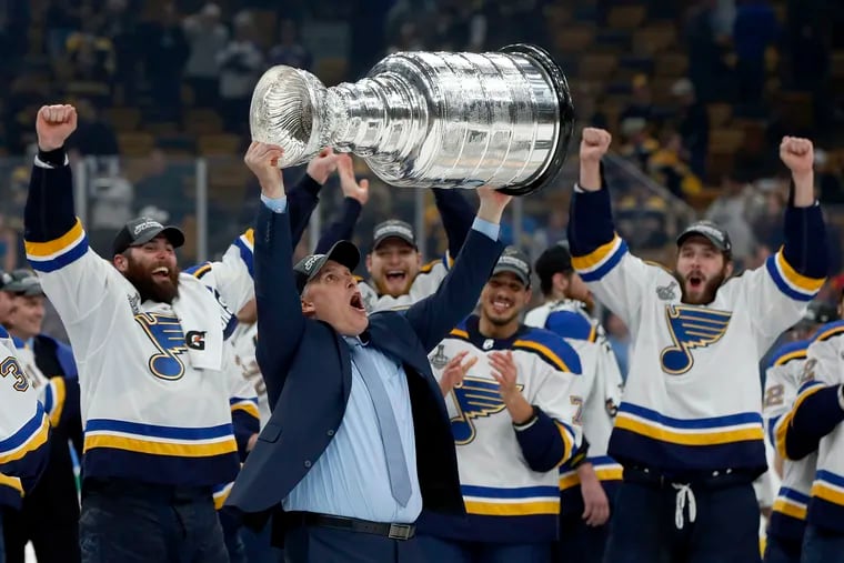 St. Louis Blues head coach Craig Berube hoists the Stanley Cup.