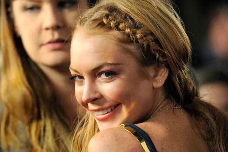 FILE - This April 11, 2013 file photo shows actress Lindsay Lohan, a cast member in "Scary Movie V," at the premiere of the film in Los Angeles. Lohan's lawyer Mark Jay Heller told a judge at a May 2, 2013 hearing that Lohan had checked into a rehab facility per a judge's orders. (Photo by Chris Pizzello/Invision/AP, file)