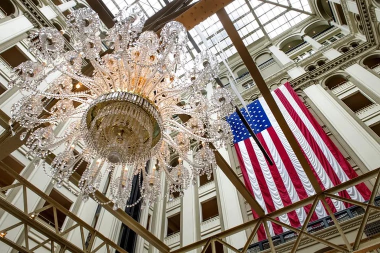 The chandelier and multistory U.S. flag in the lobby at the Trump International Hotel in Washington.