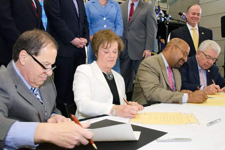 Signing the agreement are (from left) Thomas J. Giancristoforo Jr. of Tinicum Township, Kathy Hauger of Interboro School District, Mayor Nutter, and Mario Civera Jr. of Delaware County. (KENNETH D. ASTON JR.)