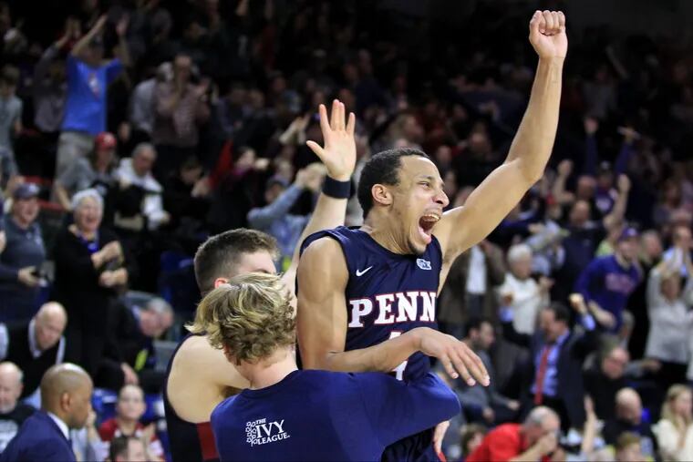 Darnell Foreman, right, of Penn leaps into the arms of Sam Jones after they defeated Harvard 74-71 in an Ivy League game at the Palestra on Feb. 24, 2018. Penn now has possession of first place in the league. CHARLES FOX / Staff Photographer