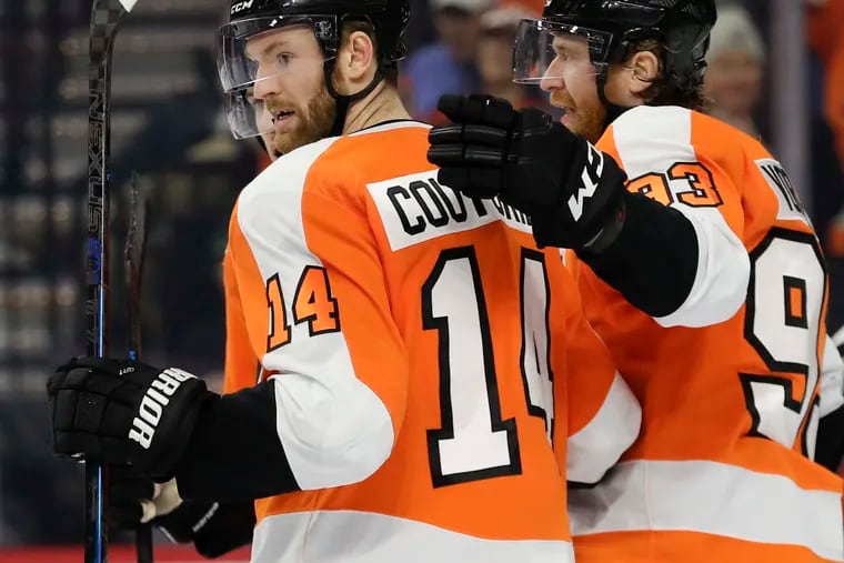 Flyers center Sean Couturier celebrates his second-period goal Monday with teammate Jake Voracek.