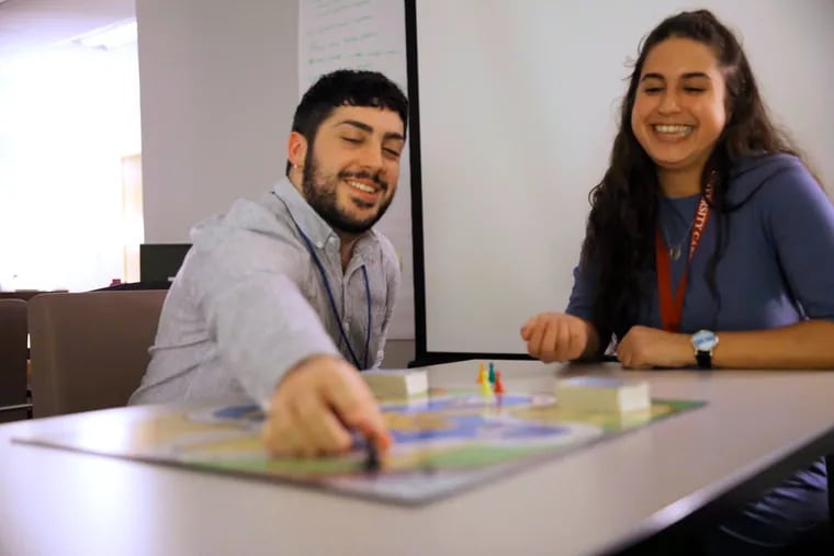 Shawn McLaughlin and Ilana Stern play a board game meant to help students build deeper connections at Temple University's Resiliency Resource Center.