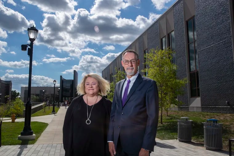 West Chester University President Christopher Fiorentino, right, stands with Provost R. Lorraine "Laurie" Bernotsky outside the school's Sciences & Engineering Center and The Commons in 2022.