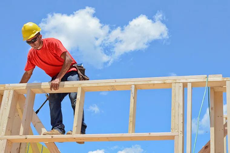 Marvin Salgero of Paiz Construction, helps build a house during Habitat for Humanity Philadelphia's three-day competition between five local construction companies on July 17, 2014. (VIVIANA PERNOT/ Staff Photographer)