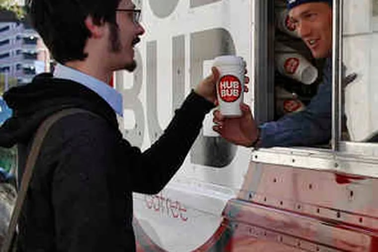Drew Crockett (in truck at left) sells a cup of Hub Bub coffee to Christopher Passanante.