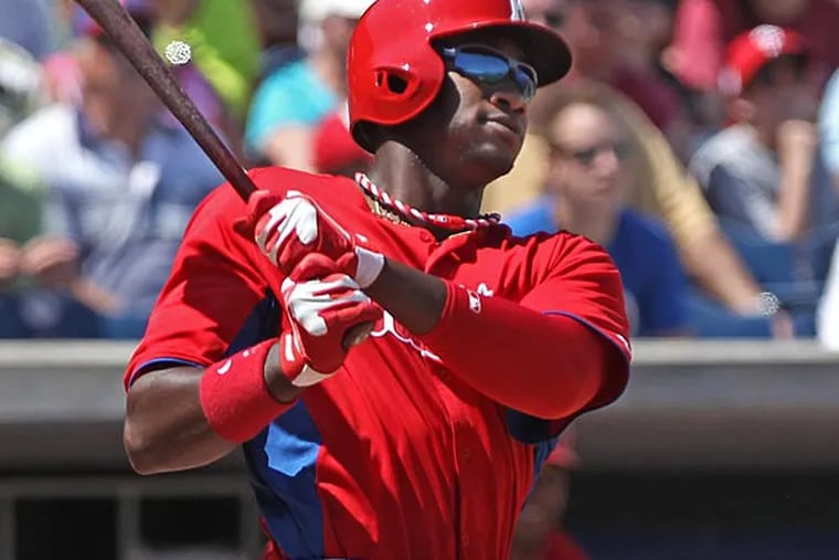 Phillies outfielder Dominic Brown watches his ball leave the yard in
the third inning for a two run homer. (Michael Bryant/Staff Photographer)