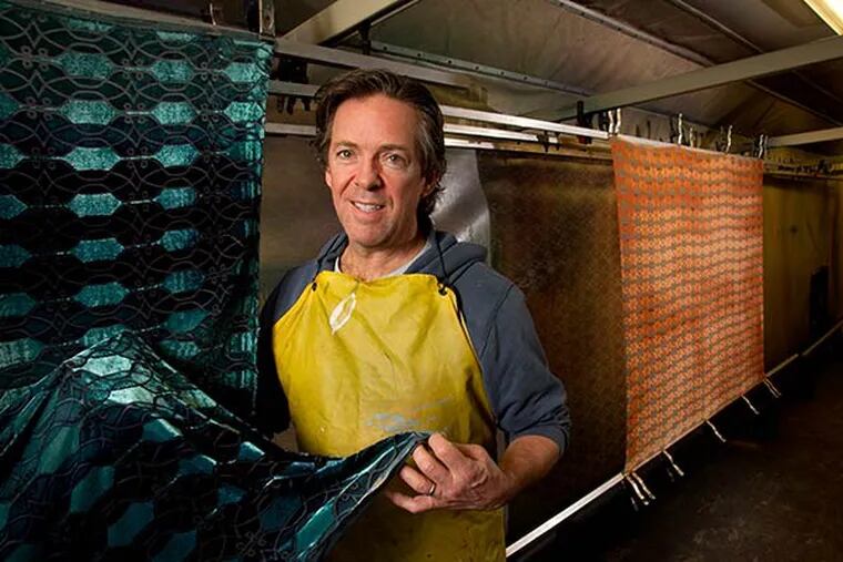 Kevin O'Brien at Kevin O'Brien Studios in Philadelphia on Thursday, December 12, 2013. Kevin is holding fabric in the dye room. ( ALEJANDRO A. ALVAREZ / STAFF PHOTOGRAPHER )