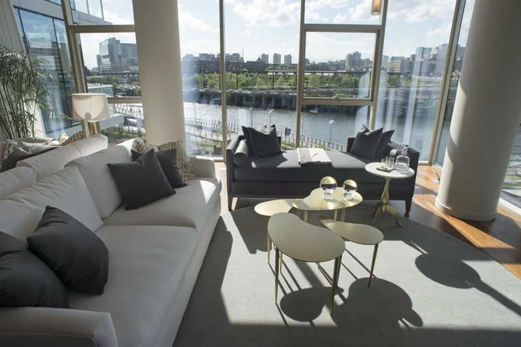 The living room of a three-bedroom unit, with a view of the Schuylkill, as Carl Dranoff's One Riverside condo complex along the river has its grand opening Tuesday.