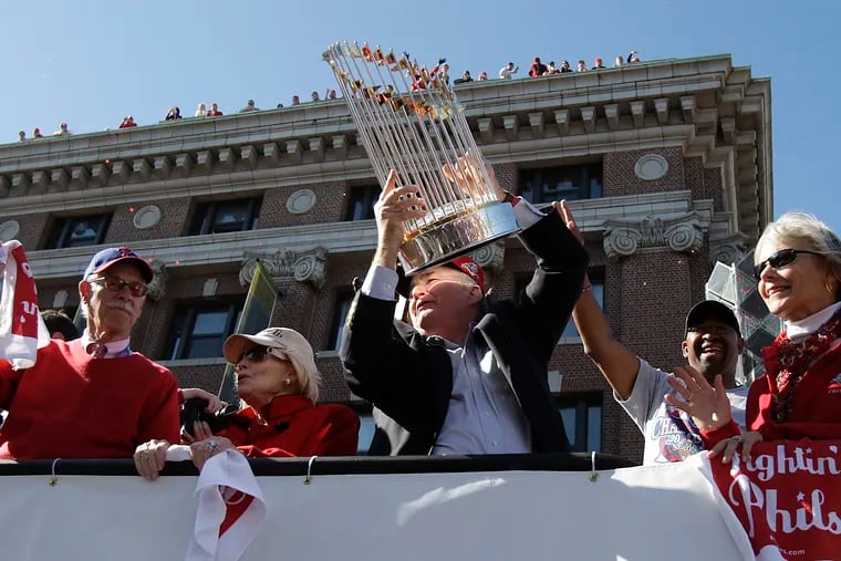 Phillies President David Montgomery holds the championship trophy up near Broad Street and Washington Ave during the Phillies World Series parade in Philadelphia, Pa., October 31, 2008. Montgomery passed away Wednesday.