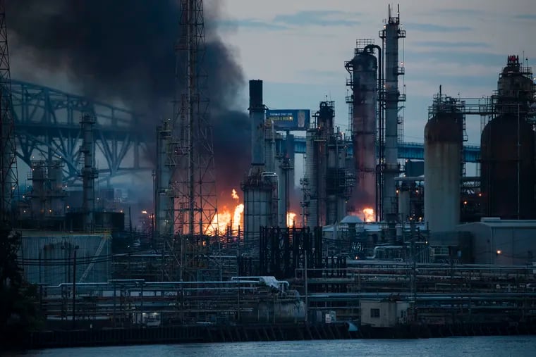 File photo shows flames and smoke emerging from the Philadelphia Energy Solutions Refining Complex in Philadelphia on June 21, 2019. Federal regulators want to fine the refinery $132,600 for safety violations related to the fire.