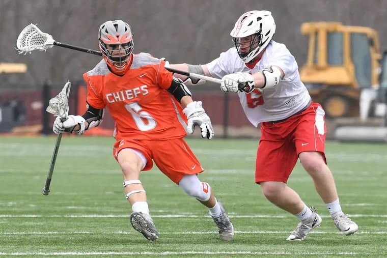 Cherokee’s Ryan Raftery (left) runs with the ball against Lenape’s Zach Cole.