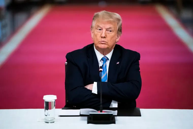 President Donald Trump crosses his arms as he participates in a roundtable discussion on the reopening of schools at the White House on July 7.