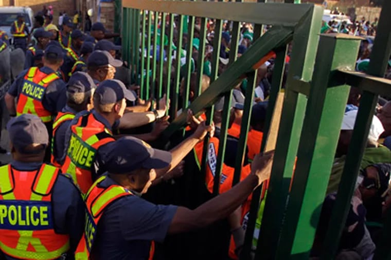 Approximately 15 people were injured in a stampede outside of Makhulong Stadium near Johannesburg. (Frank Augstein/AP)