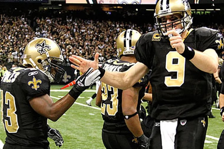 Saints quarterback Drew Brees, right, celebrates throwing a touchdown pass with running back Darren Sproles, left. (Bill Haber/AP)