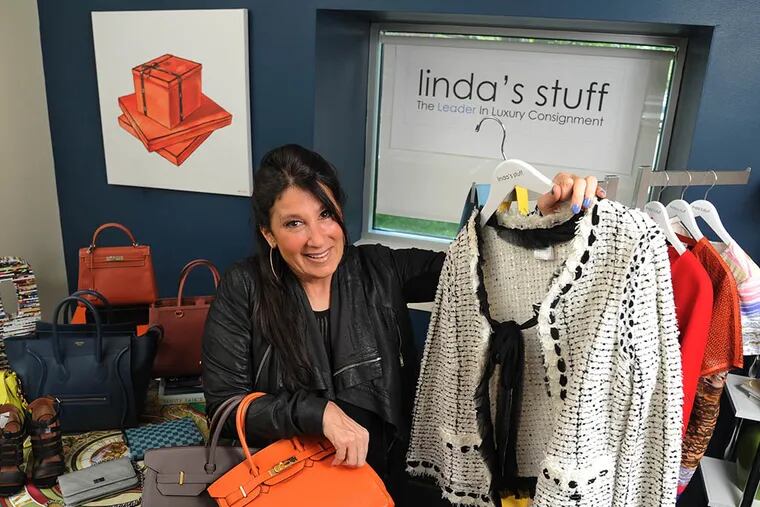 Linda Lightman, 53, founder and CEO of Linda's Stuff, is surrounded by some of the luxury items she sells on consignment for others including a Chanel coat and Hermes Birkin handbags on May 4, 2015. ( CLEM MURRAY / Staff Photographer )