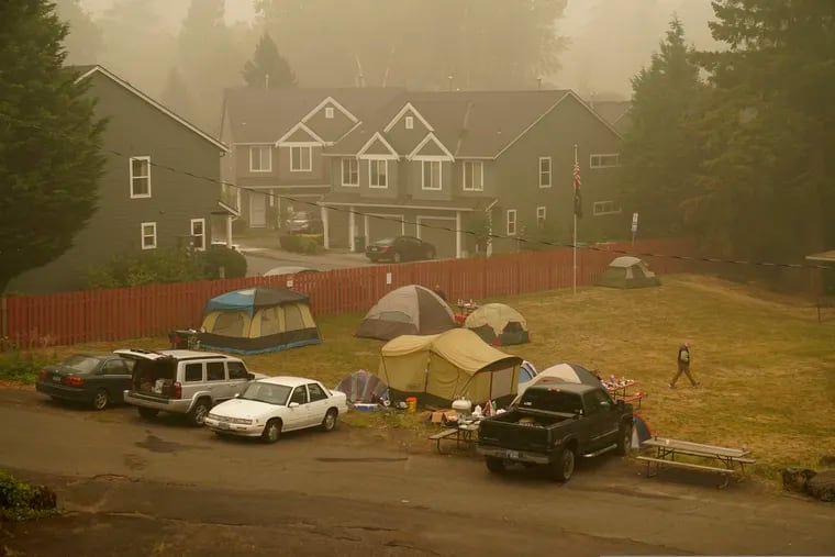 Evacuees from the Riverside Fire stay in tents at the Milwaukie-Portland Elks Lodge in Oak Grove, Calif., on Sunday.