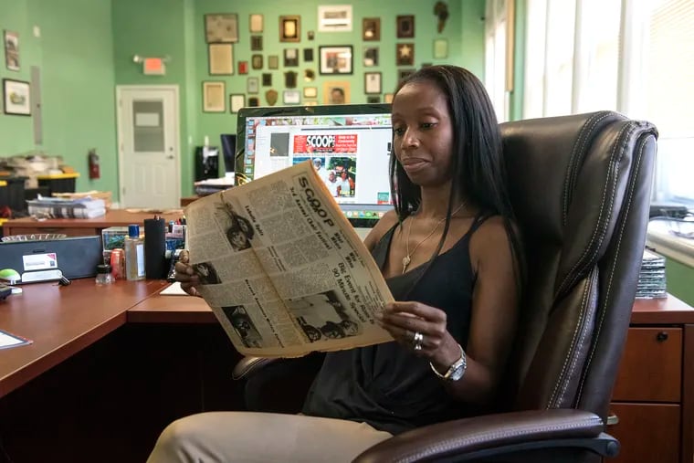 Sherri Horsey Darden, new owner and publisher of Scoop USA, looks at an older edition of Scoop USA while working on the latest paper in the Scoop USA office on Thursday, July 19, 2018. Scoop USA is a black-owned community newspaper that was started back in 1960.