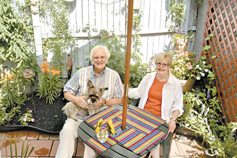 Frank and Bonnie Hollick sit under the umbrella of their backyard patio at their home in Mount Airy. (Ron Tarver / Staff Photographer)