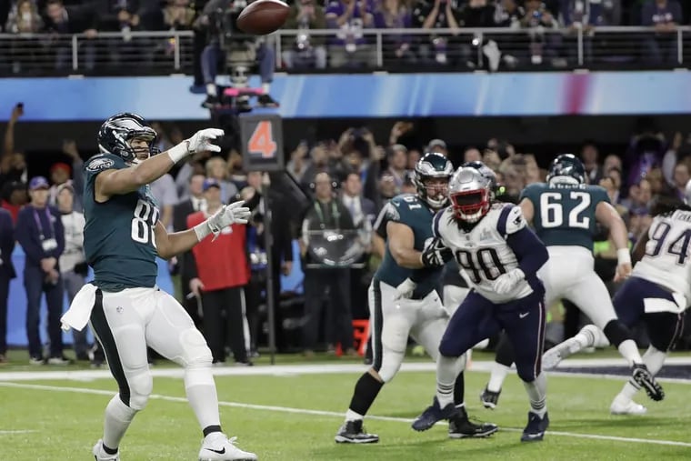 Eagles tight end Trey Burton, left, throws a touchdown pass to Nick Foles during the first half of the Super Bowl on Sunday.