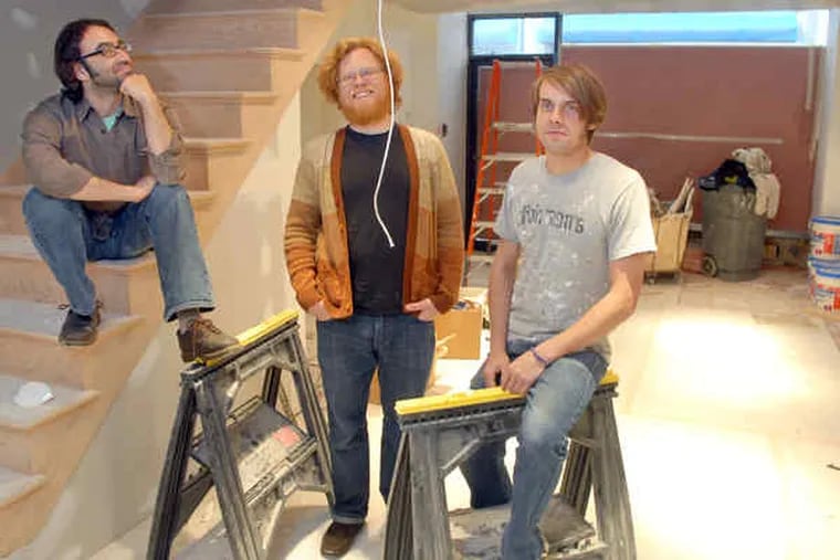 Pop life: Hoots and Hellmouth - from left, Robert Berliner, Sean Hoots and Andrew Gray - pose in a Center City store during a lunch break for Gray, a part-time construction worker.