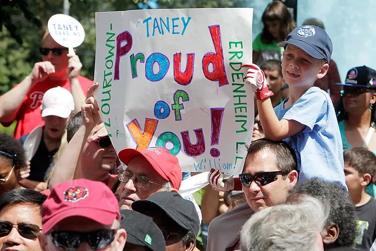 A young fan of the Dragons holds a sign during the welcoming rally at LOVE Park.